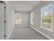 Bedroom features 3 windows allowing natural light and plush gray carpet throughout at 9639 Clubvalley Way, Raleigh, NC 27617