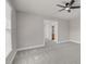 A bright bedroom featuring gray walls, plush carpet, and a contemporary ceiling fan at 9639 Clubvalley Way, Raleigh, NC 27617