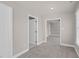 Bedroom hallway features neutral gray carpeting and paint, with doorways to other rooms at 9639 Clubvalley Way, Raleigh, NC 27617
