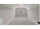 A long, walk-in closet provides plenty of storage and features a small window at 9639 Clubvalley Way, Raleigh, NC 27617