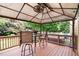 Inviting covered deck with seating, ceiling fan, and outdoor lights, ideal for relaxing and enjoying the view at 9639 Clubvalley Way, Raleigh, NC 27617