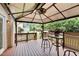 Covered deck featuring a ceiling fan and outdoor seating offering a cozy spot for relaxation and gatherings at 9639 Clubvalley Way, Raleigh, NC 27617