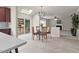 View of kitchen island looking into the dining and living area with patio access at 9639 Clubvalley Way, Raleigh, NC 27617