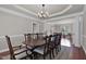 Elegant dining room with tray ceiling, crown molding and large table for entertaining at 9639 Clubvalley Way, Raleigh, NC 27617