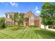 Charming two-story brick home with an arched entry and a well-manicured lawn at 9639 Clubvalley Way, Raleigh, NC 27617