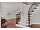 Elegant foyer with hardwood floors and curved staircase leading to the upper level at 9639 Clubvalley Way, Raleigh, NC 27617