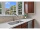 Close up of sink area featuring stainless steel sink, white countertops and view from multi-pane window at 9639 Clubvalley Way, Raleigh, NC 27617