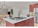 Spacious kitchen island with built-in gas cooktop and breakfast bar, with view to the dining and living areas at 9639 Clubvalley Way, Raleigh, NC 27617