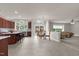 Open-concept living space featuring a kitchen, dining area, and living room with neutral tile flooring at 9639 Clubvalley Way, Raleigh, NC 27617