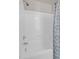 Shower tub with white tile walls and curtain with white, blue, and gray pattern at 9639 Clubvalley Way, Raleigh, NC 27617
