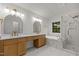 This luxurious bathroom is bright with a double vanity, soaking tub, and glass shower at 100 Citrus Pl, Cary, NC 27519