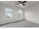 This bedroom offers two bright windows, neutral walls, carpeted floors, and a ceiling fan at 100 Citrus Pl, Cary, NC 27519