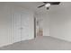 This bedroom boasts neutral walls, carpeted floors, a ceiling fan, and closet space at 100 Citrus Pl, Cary, NC 27519