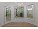 Dining room with view of glass door and large windows allowing plenty of natural light at 100 Citrus Pl, Cary, NC 27519