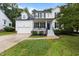 Charming two-story home with well-maintained lawn, two-car garage, black shutters, and front porch at 100 Citrus Pl, Cary, NC 27519