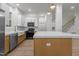 Kitchen featuring a white farmhouse sink, white subway tile backsplash and a view of the staircase at 100 Citrus Pl, Cary, NC 27519