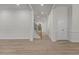 Bright living area with light wood flooring, trim, columns, open staircase and ample natural light at 100 Citrus Pl, Cary, NC 27519