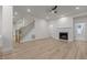 Large living room area featuring wooden floors, fireplace, and staircase at 100 Citrus Pl, Cary, NC 27519