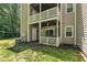 Backyard with covered porch, lattice enclosure, and mature trees at 101 Oyster Bay Ct # B2, Cary, NC 27513