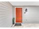 An entryway with orange door, exterior lantern light, and planter at 101 Oyster Bay Ct # B2, Cary, NC 27513