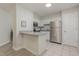 An open kitchen has a granite countertop bar, stainless steel appliances, and white cabinetry at 101 Oyster Bay Ct # B2, Cary, NC 27513