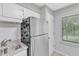 Kitchen with stainless steel refrigerator, granite countertops, and a window at 101 Oyster Bay Ct # B2, Cary, NC 27513