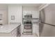 This kitchen features stainless steel appliances, subway tile, granite countertops and lots of lighting at 101 Oyster Bay Ct # B2, Cary, NC 27513