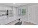 Bright kitchen with white cabinets, granite countertops, a window, and a back door at 101 Oyster Bay Ct # B2, Cary, NC 27513
