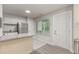 A well-lit kitchen features granite countertops, white cabinets, stainless steel appliances and a bright window at 101 Oyster Bay Ct # B2, Cary, NC 27513