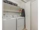 Efficient laundry room with a washer, dryer, storage shelves and white walls at 101 Oyster Bay Ct # B2, Cary, NC 27513