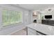 Living room with a fireplace, gray flooring, and a connecting kitchen at 101 Oyster Bay Ct # B2, Cary, NC 27513