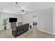 Living room with light wood floors, a ceiling fan, and a view into the bedroom at 101 Oyster Bay Ct # B2, Cary, NC 27513