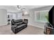 Living room features a fireplace, window with blinds, and a view into the kitchen at 101 Oyster Bay Ct # B2, Cary, NC 27513