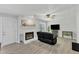Living room featuring a fireplace, dark couch, and a ceiling fan at 101 Oyster Bay Ct # B2, Cary, NC 27513