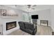 Living room featuring a fireplace, dark couch, and gray flooring at 101 Oyster Bay Ct # B2, Cary, NC 27513