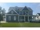 Beautiful two-story home with a manicured lawn, inviting front porch, and classic architectural details at 1017 Azalea Garden Cir, Raleigh, NC 27603