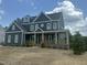 Charming two-story home with a welcoming front porch and beautiful architectural details, and professionally landscaped yard at 1017 Azalea Garden Cir, Raleigh, NC 27603