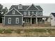 Two-story home featuring a charming facade with a covered front porch and craftsman-style details at 1017 Azalea Garden Cir, Raleigh, NC 27603