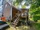 Backyard view featuring an elevated deck with wooden stairs at 103 N Woods Rd, Henderson, NC 27536