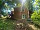 A view of the house from the back yard, highlighting a brick foundation at 103 N Woods Rd, Henderson, NC 27536