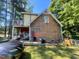 Side view showcasing the home's architecture, wood siding and deck at 103 N Woods Rd, Henderson, NC 27536