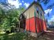 Side view of a multi-level home with a mix of siding and brick details at 103 N Woods Rd, Henderson, NC 27536
