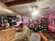 Spacious living room with a sofa, movie posters, and a foosball table at 103 N Woods Rd, Henderson, NC 27536