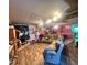 Spacious living room with a sofa, movie posters, and wood flooring at 103 N Woods Rd, Henderson, NC 27536