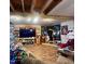 Basement living room with wood flooring, large screen TV, and Star Wars themed decor at 103 N Woods Rd, Henderson, NC 27536