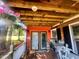 Relaxing porch area with rustic wooden accents, adorned with hanging plants at 103 N Woods Rd, Henderson, NC 27536