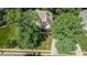 Aerial view of a home with mature trees, a large driveway, and well-maintained landscaping at 108 Ellsworth Pl, Chapel Hill, NC 27516