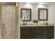 Vanity area in bathroom featuring dual sinks, granite countertops and a glass enclosed shower at 108 Ellsworth Pl, Chapel Hill, NC 27516