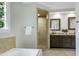 Bathroom featuring a soaking tub, glass shower and double vanity with granite countertop at 108 Ellsworth Pl, Chapel Hill, NC 27516