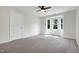 Bedroom with carpeting, a large window, and a ceiling fan for optimal comfort at 108 Ellsworth Pl, Chapel Hill, NC 27516
